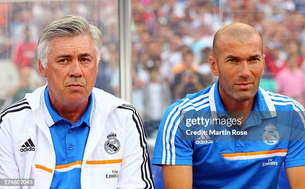 Carlo Ancelotti , head coach of Real Madrid and assistant coach Zinedine Zidane look on before the pre season friendly match between Real Madrid and...