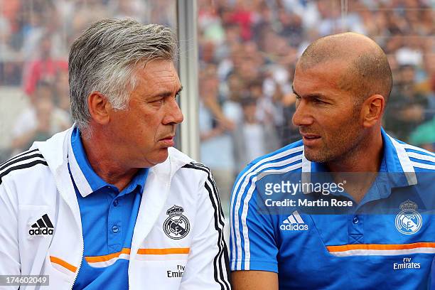 Carlo Ancelotti , head coach of Real Madrid and assistant coach Zinedine Zidane look on before the pre season friendly match between Real Madrid and...