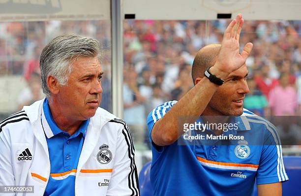 Carlo Ancelotti , head coach of Real Madrid and assistant coach Zinedine Zidane look on before the pre season friendly match between Real Madrid and...