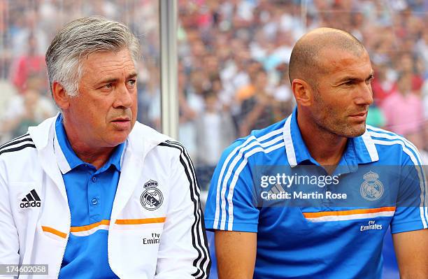 Carlo Ancelotti , head coach of Real Madrid and assistant coach Zinedine Zidane look on before the pre season friendly match between Real Madrid and...