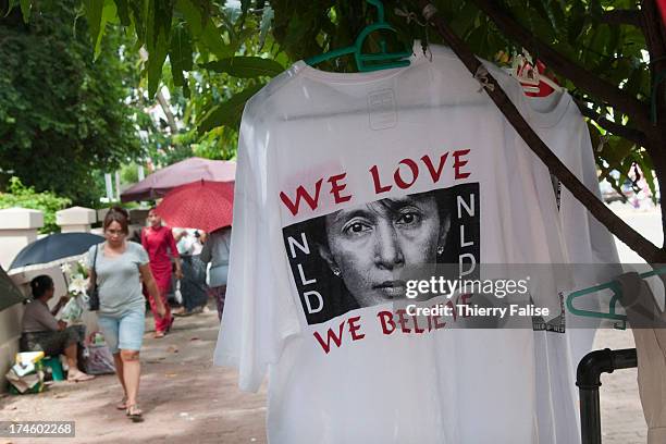 Shirts bearing portraits of Aung San Suu Kyi and the logo of her party, the National League for Democracy , are sold on a Yangon street...