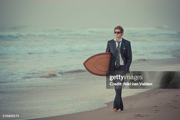 suit and surf 5 - beach holding surfboards stock pictures, royalty-free photos & images