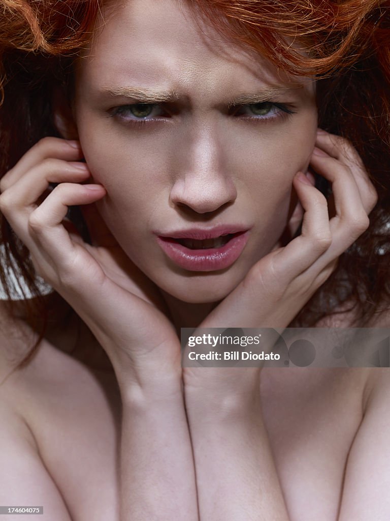 Redhead girl with fearful look