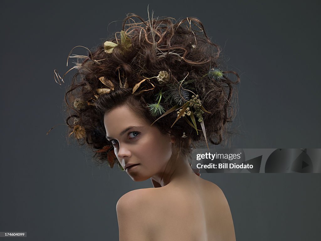 Young woman with dried flowers in hair