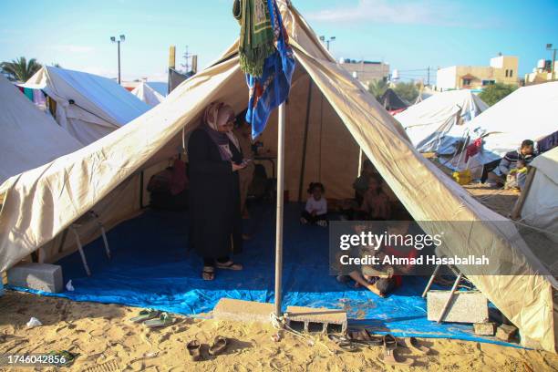 Palestinians rest in a refugee tent along the Gaza Strip on October 20, 2023 in Khan Yunis, Gaza. Gazans are evacuating to the south as advised by...