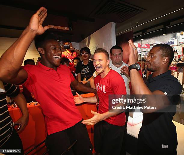 Danny Welbeck, Tom Cleverley and Patrice Evra of Manchester United FC play table football after a Q&A session at the Nike store, Mong Kok as part of...