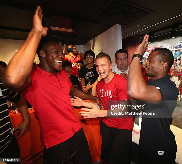 Danny Welbeck, Tom Cleverley and Patrice Evra of Manchester United FC play table football after a Q&A session at the Nike store, Mong Kok as part of...