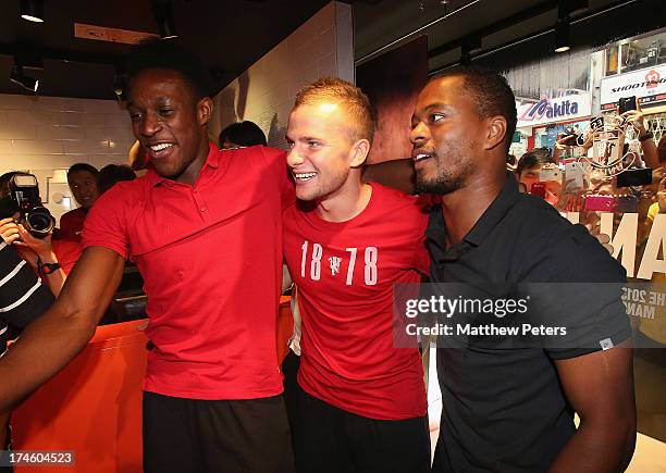 Danny Welbeck, Tom Cleverley and Patrice Evra of Manchester United FC play table football after a Q&A session at the Nike store, Mong Kok as part of...