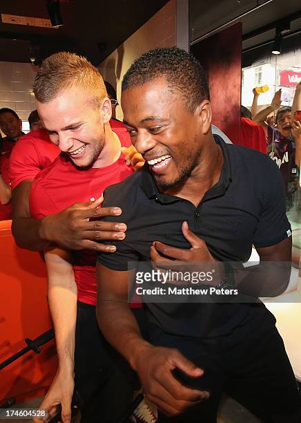 Danny Welbeck, Tom Cleverley and Patrice Evra of Manchester United FC play table football after a Q&A session at the Nike store, Mong Kok as part of...