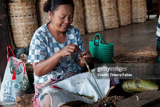 Woman makes a cheroot, the traditional Burmese cigar, in a Kyaukme factory..