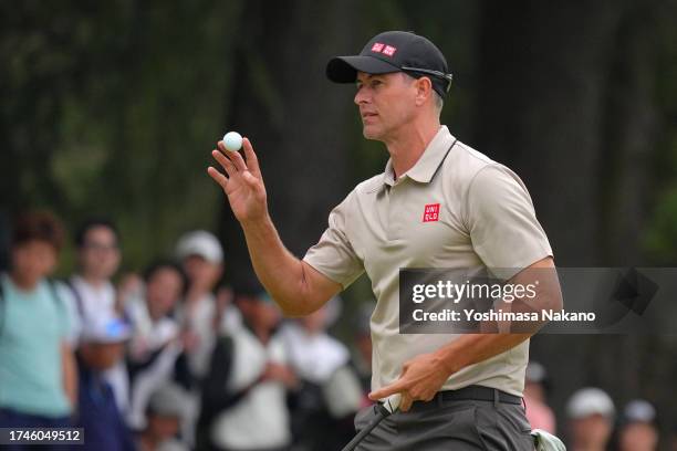 Adam Scott of Australia acknowledges the gallery after holing out with the birdie on the 18th green during the second round of ZOZO Championship at...