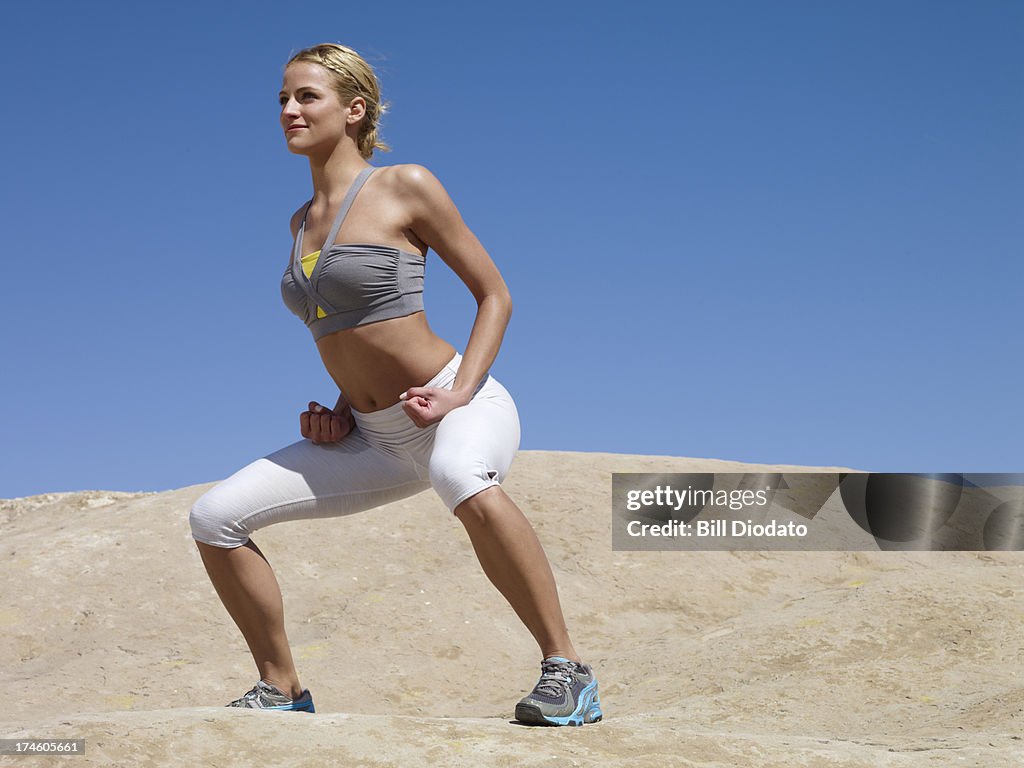 Woman exercising doing thai chi in the desert