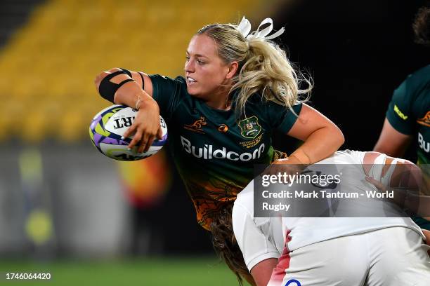 Carys Dallinger of Australia offloads the ball during the WXV1 Match between England and Australia Wallaroos at Sky Stadium on October 20, 2023 in...