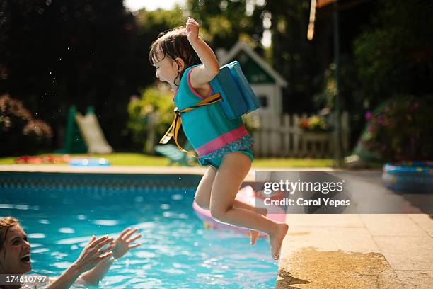 jumping to the pool - kid jumping into swimming pool stock pictures, royalty-free photos & images