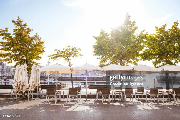 cafe terraces with umbrellas in the city - gijón imagens e fotografias de stock