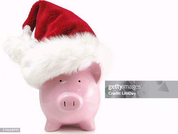 piggy bank with santa hat - christmas budget stock pictures, royalty-free photos & images