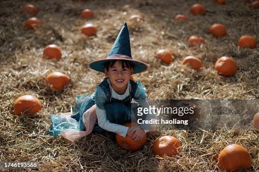 Little witch picking pumpkin