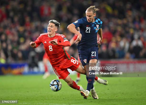 Harry Wilson of Wales is tackled by Domagoj Vida of Croatia during the UEFA EURO 2024 European qualifier match between Wales and Croatia at Cardiff...