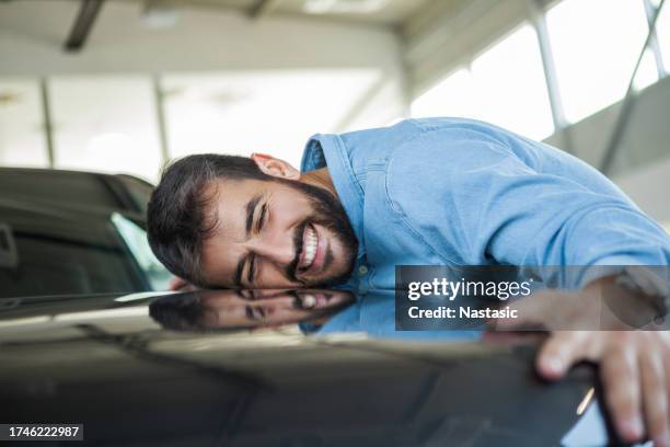 man is looking to buy car in auto salon - kissing stock pictures, royalty-free photos & images