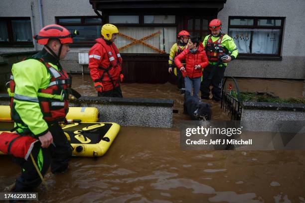 Members of the coastguard rescue a family from flood waters surrounding the houses on October 20, 2023 in Brechin, Scotland. Areas close to the river...