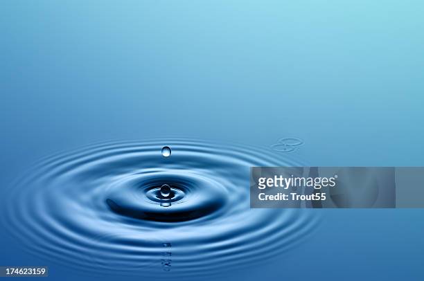 single drop of water hitting a larger body of water - drop stock pictures, royalty-free photos & images