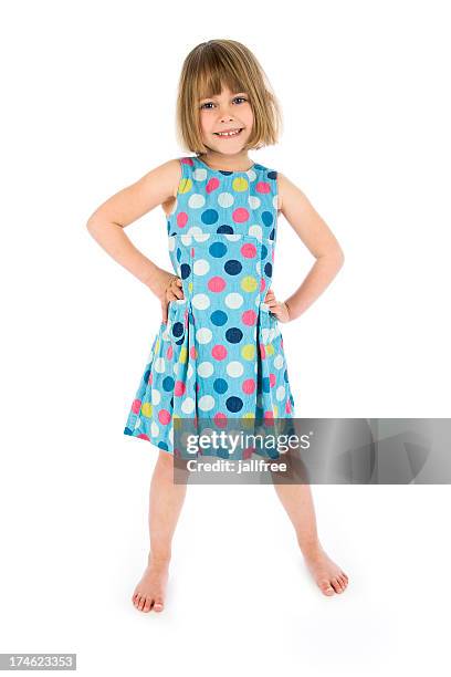 happy girl with hands on hips on white background - spotty dress stock pictures, royalty-free photos & images