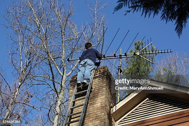 chimney sweep working on a ladder - chimney sweep stock pictures, royalty-free photos & images