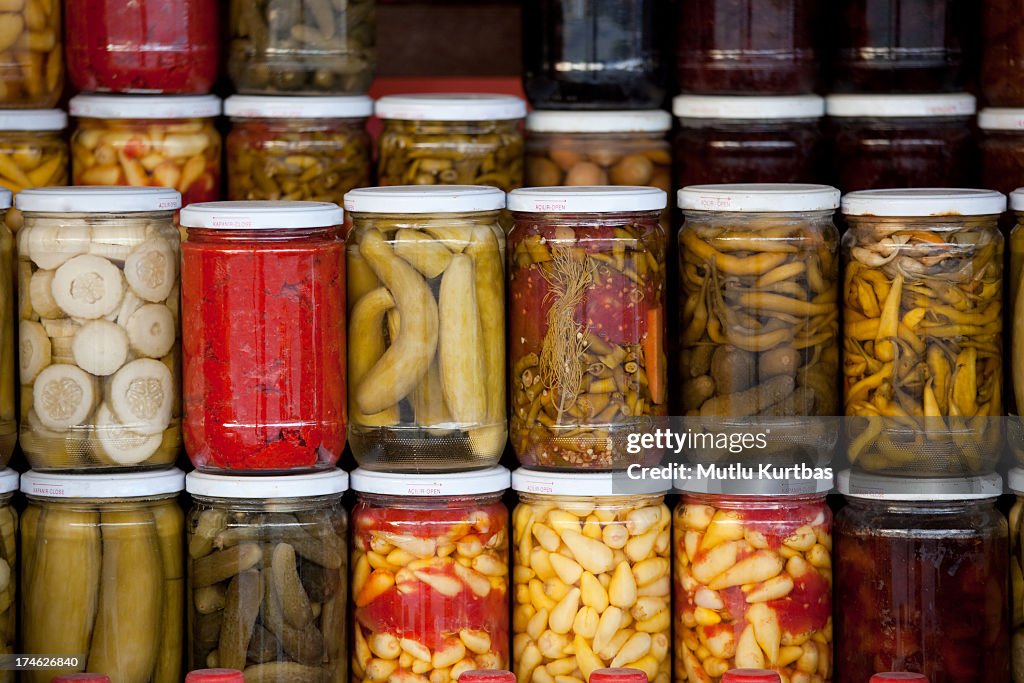 Assortment of glass jars filled with pickled vegetables
