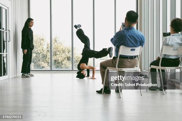 breakdancer training with coach in dance studio. - dancing studio shot stock pictures, royalty-free photos & images