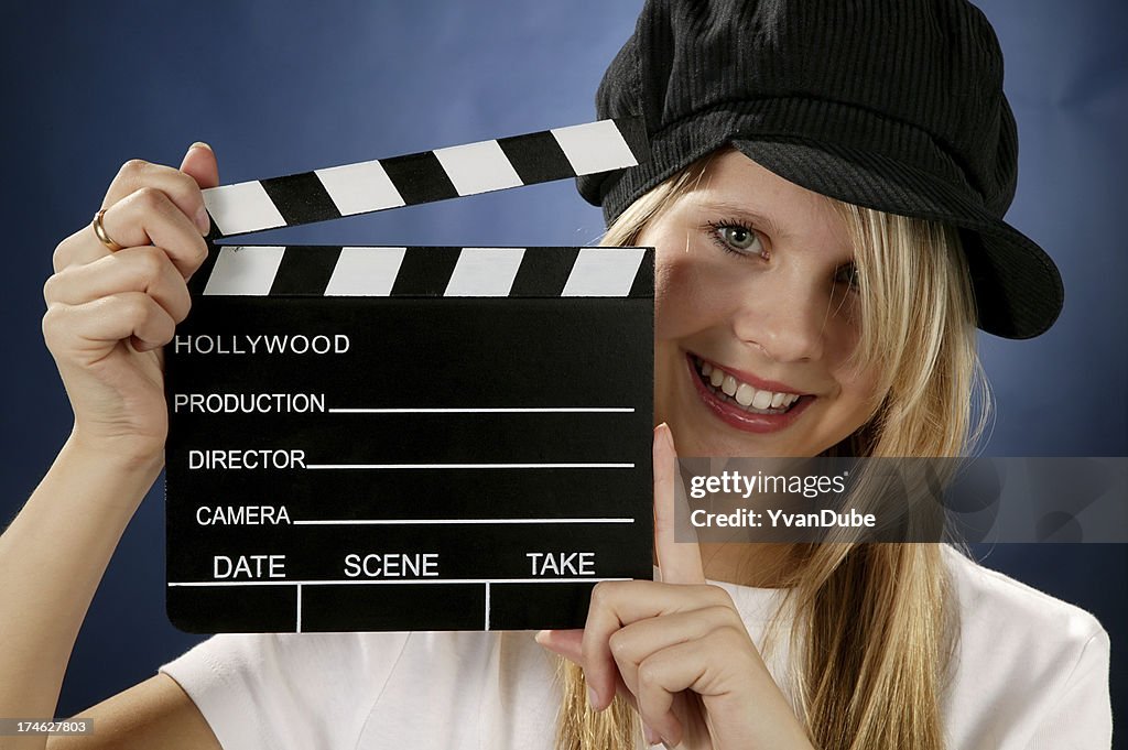 Young woman with movie action clapboard