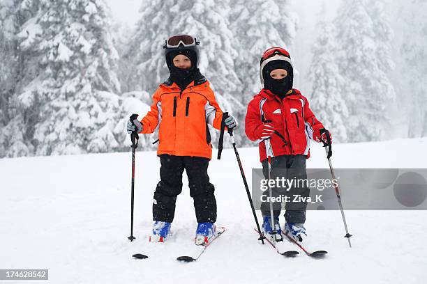 two little skiers - skischoen stockfoto's en -beelden