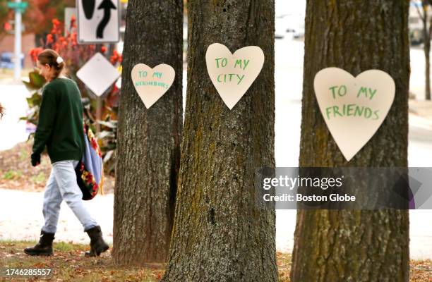 Lewiston, ME Artist Miia Zellner walks away after nailing hearts she made to trees on Main Street the day after a mass shooting took place in the...
