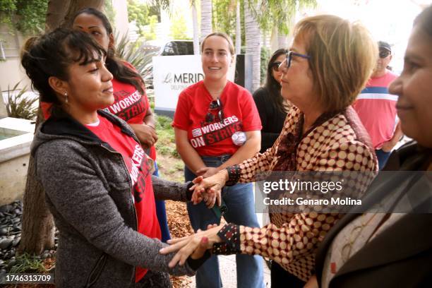 State Sen. Maria Elena Durazo, left, reaches out to Norelis Vargas, left, from Venezuela, as Hannah Peterson, center, organizer with UNITE HERE Local...