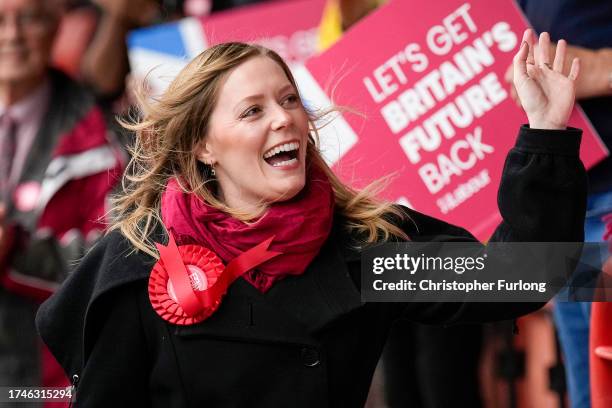 Labour candidate Sarah Edwards waves as she walks next to Labour Party leader Keir Starmer after winning the Tamworth by-election on October 20, 2023...