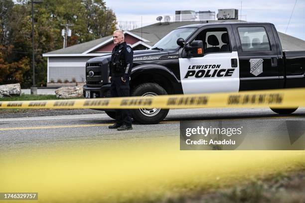 Security forces take measures at the site where at least 18 people were killed and 13 injured in a mass shooting in Maine, United States on October...