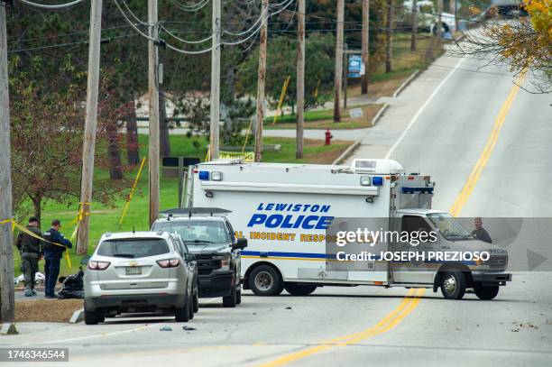 Police back a up a truck at Schemengees Bar where a mass shooting occurred yesterday in Lewiston, Maine on October 26, 2023. A massive manhunt was...
