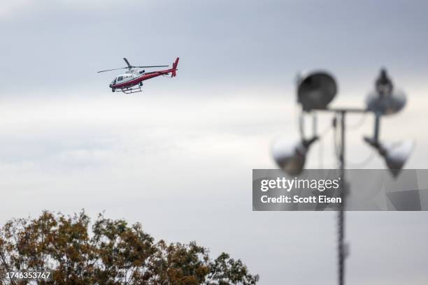 Helicopter flies low along the Androscogin River during the manhunt for the suspect in a mass shooting near Schemengees Bar and Grille on October 26,...
