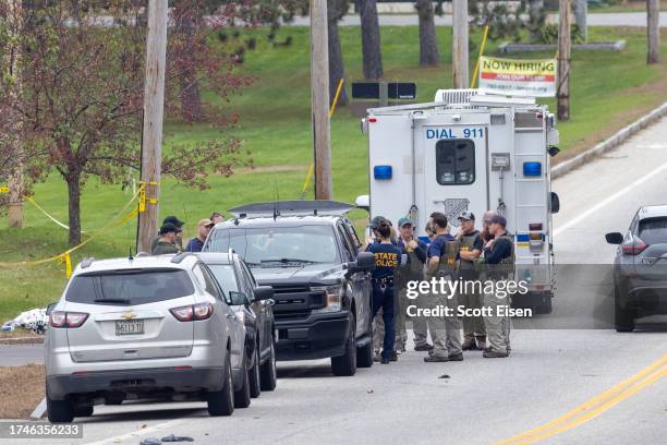 Members of the FBI Evidence Response Team and State Police gather at the site of a mass shooting at Schemengees Bar and Grille on October 26, 2023 in...