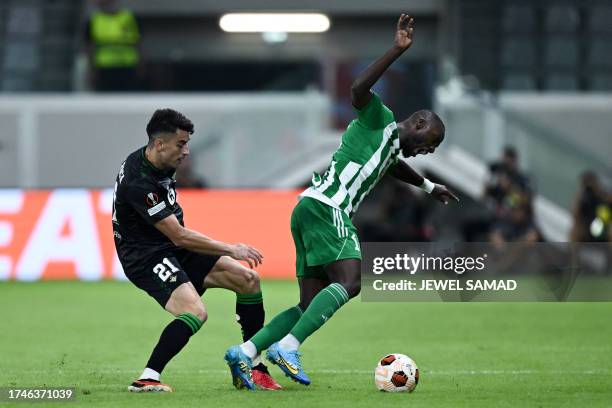 Real Betis' Spanish midfielder Marc Roca fights for the ball with Aris Limassol's Senegalese forward Yannik Arthur Gomis during the UEFA Europa...