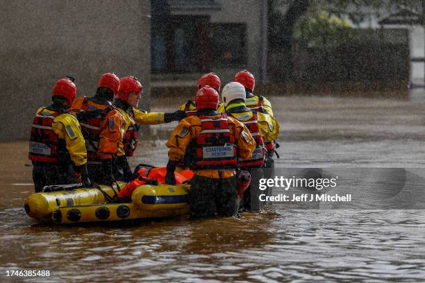 Members of the coastguard rescue team wade through the flood waters to check on people in houses on October 20, 2023 in Brechin Scotland. Areas close...