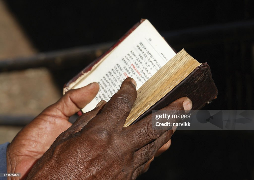 Worshipper Reading Holy Bible in Lalibela Ethiopia