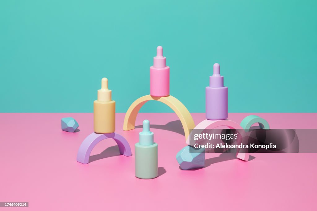 3D stage with set of cute kawaii pastel colorful cosmetics bottles on pink table with abstract geometric figures on turquoise mint green background.