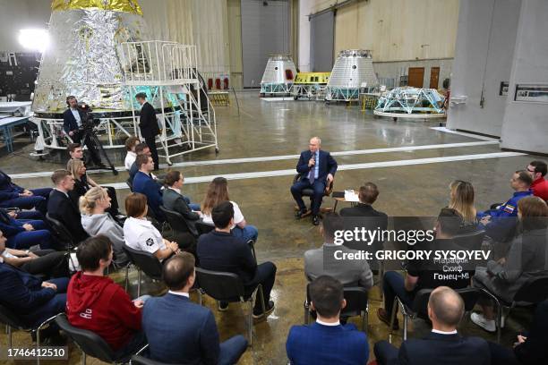 This pool photograph distributed by Russian state owned agency Sputnik shows Russia's President Vladimir Putin talking with young scientists during a...