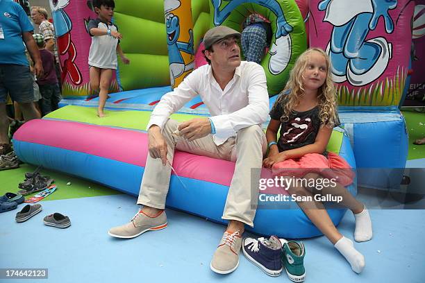 Gedeon Burkhard and daughter Gioia Filomena attend the 'Die Schluempfe 2' Germany Premiere at Sony Centre on July 28, 2013 in Berlin, Germany.