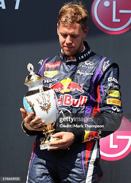 Sebastian Vettel of Germany and Infiniti Red Bull Racing celebrates on the podium after finishing third during the Hungarian Formula One Grand Prix...