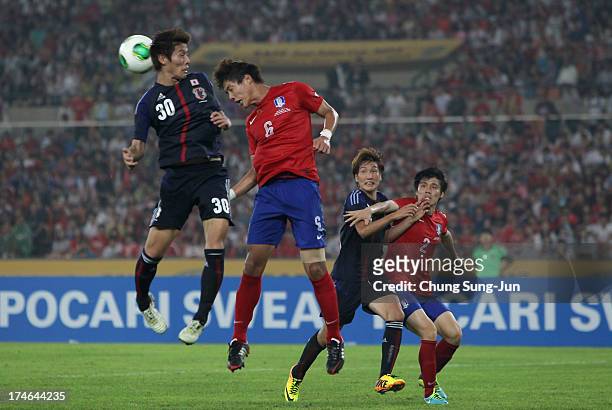 Yoichiro Kakitani of Japan competes for the ball with Hong Jeong-Ho of South Korea during the EAFF East Asian Cup match between Korea Republic and...