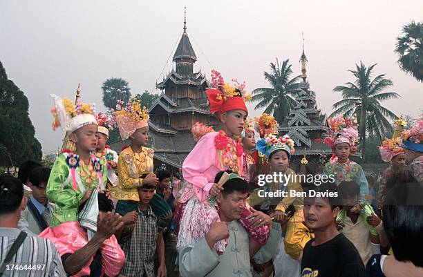 Novices dressed like princes are carried around Wat Hua Wiang by their friends and family as part of the annual Poi Sang Long procession to celebrate...