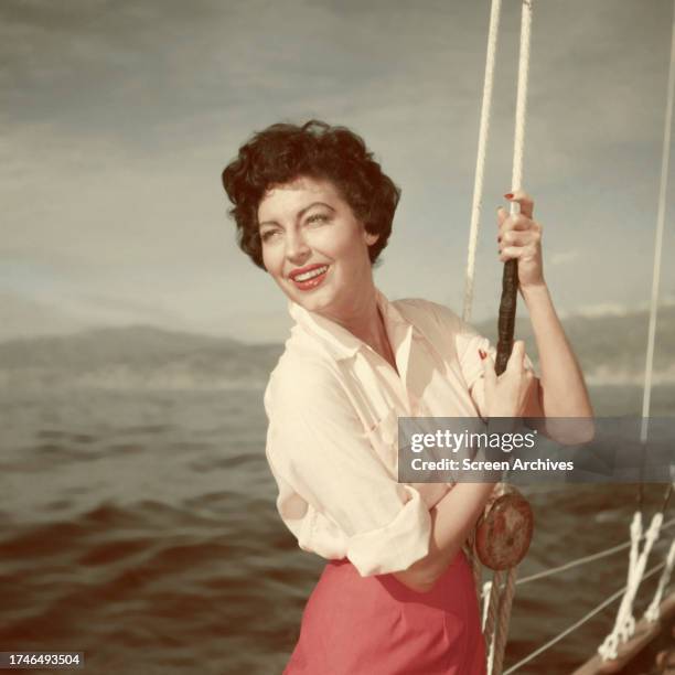 Ava Gardner poses on yacht holding fishing rod circa 1953.