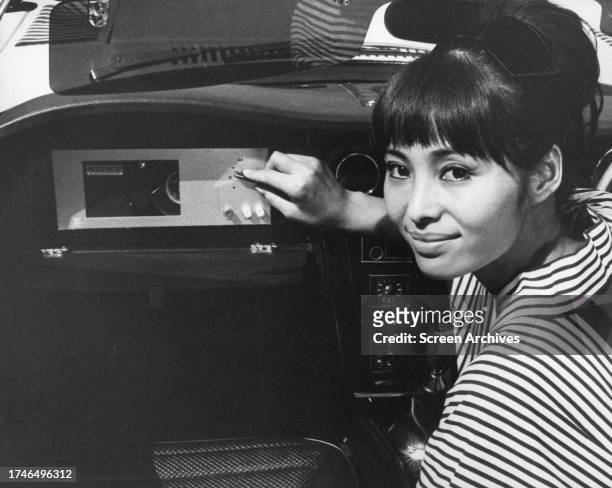 Akiko Wakabayashi as Japanese Secret Service Agent Aki from the 1967 James Bond movie 'You Only Live Twice', demonstrating the special gadgets in the...