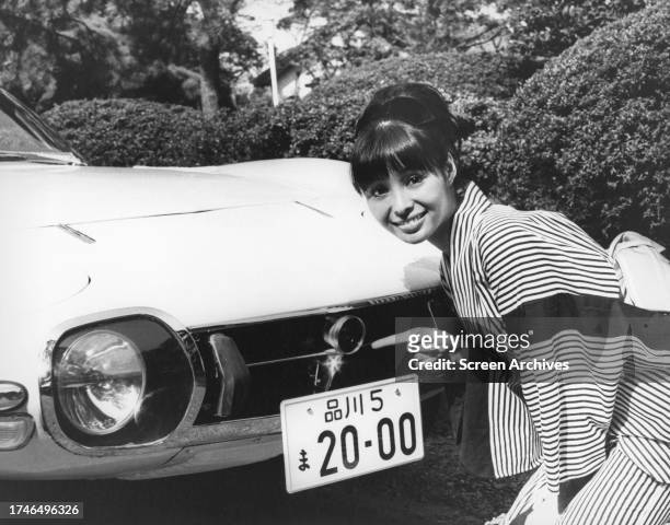Akiko Wakabayashi poses by Toyota sports car as Japanese Secret Service Agent Aki from the James Bond movie 'You Only Live Twice' 1967.